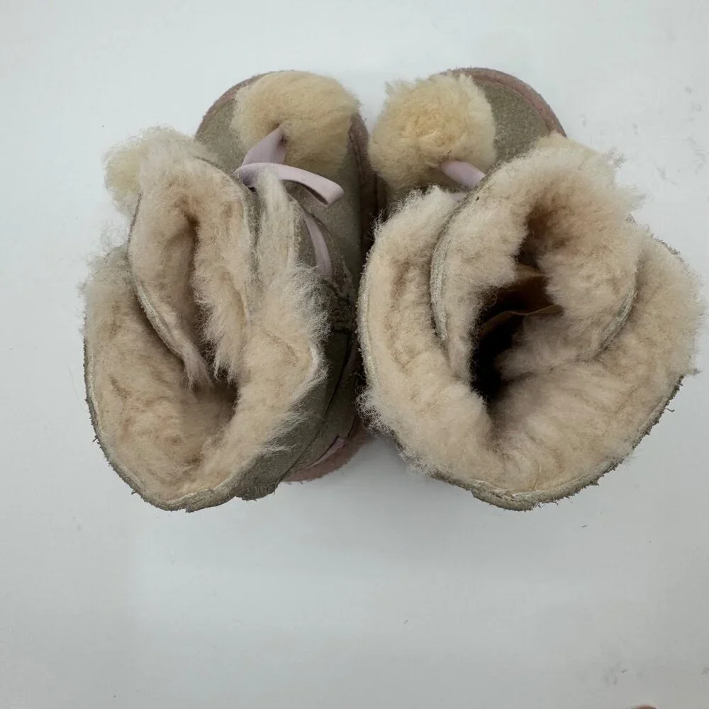 UGG Infant Girls Metallic Gold Sheepskin Bow Booties With Pom-Poms - Picture 9 of 11
